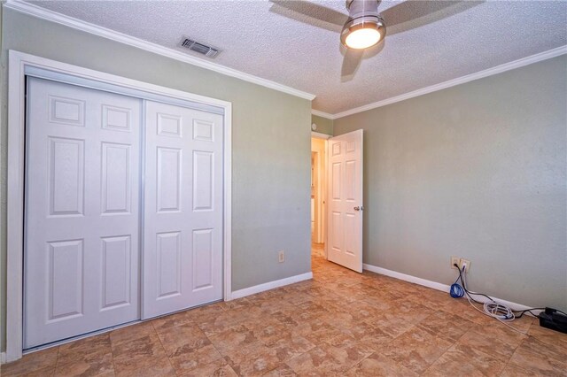 5372 County Road 73a, Robstown, TX 78380 - unfurnished bedroom featuring a textured ceiling, ornamental molding, a closet, and ceiling fan