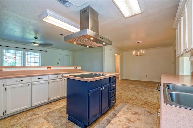 5372 County Road 73a, Robstown, TX 78380 - kitchen with exhaust hood, blue cabinetry, black electric cooktop, white cabinets, and a chandelier