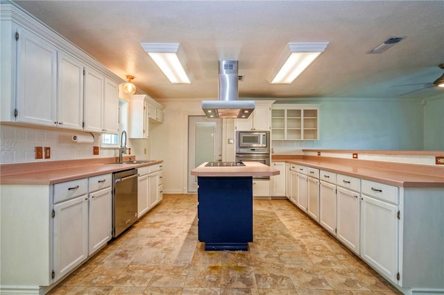 5372 County Road 73a, Robstown, TX 78380 - kitchen featuring stainless steel appliances, island exhaust hood, a kitchen island, a peninsula, and backsplash