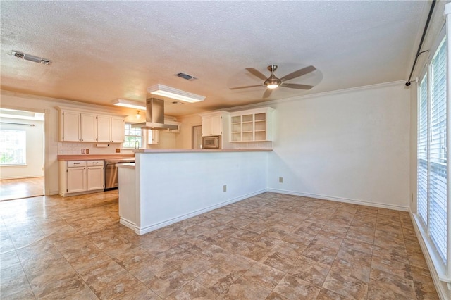 5372 County Road 73a, Robstown, TX 78380 - kitchen featuring exhaust hood, ceiling fan, a peninsula, a textured ceiling, and ornamental molding