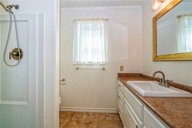 5372 County Road 73a, Robstown, TX 78380 - full bathroom featuring vanity, a shower, crown molding, and stone finish flooring