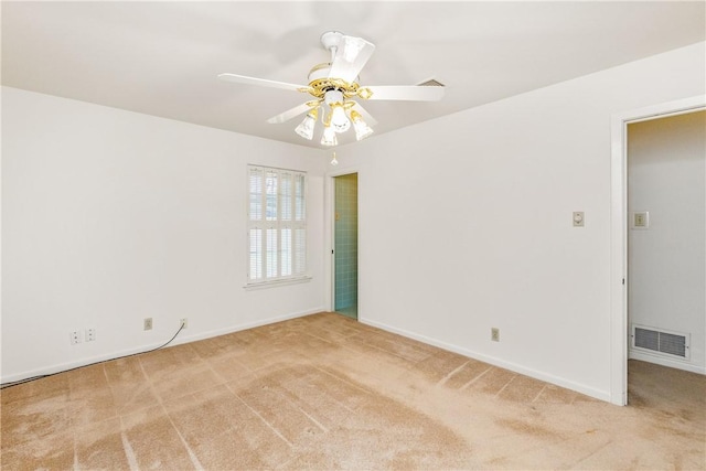spare room with ceiling fan and light colored carpet