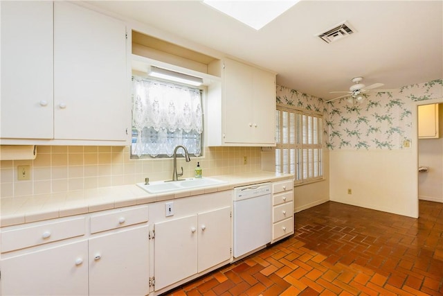 kitchen featuring white cabinetry, ceiling fan, dishwasher, and sink