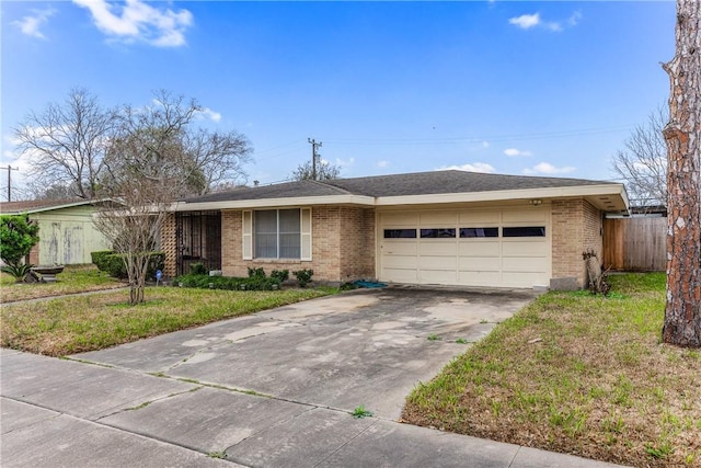 ranch-style house featuring a garage and a front lawn