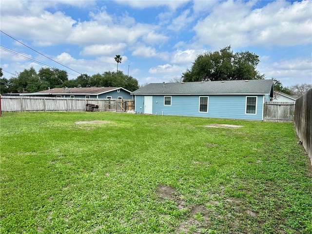 rear view of house featuring a yard