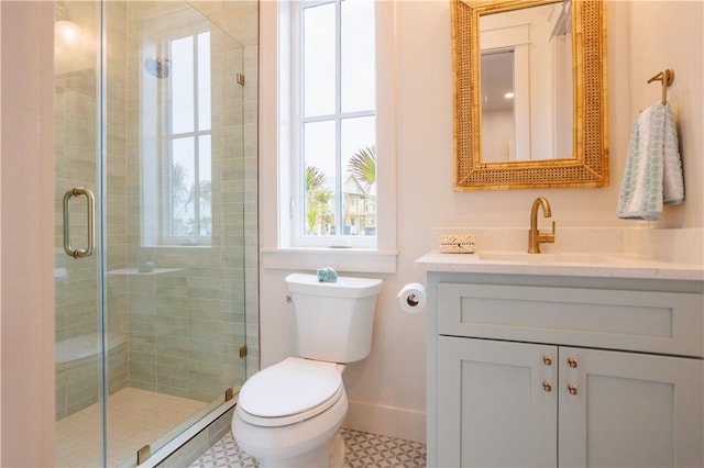 bathroom with vanity, walk in shower, and toilet