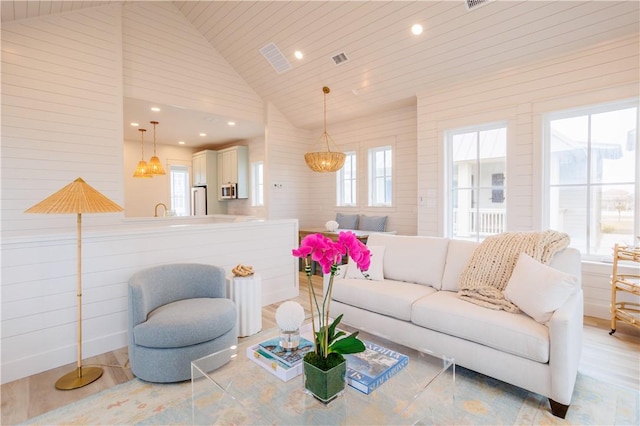 living room with high vaulted ceiling and wooden ceiling