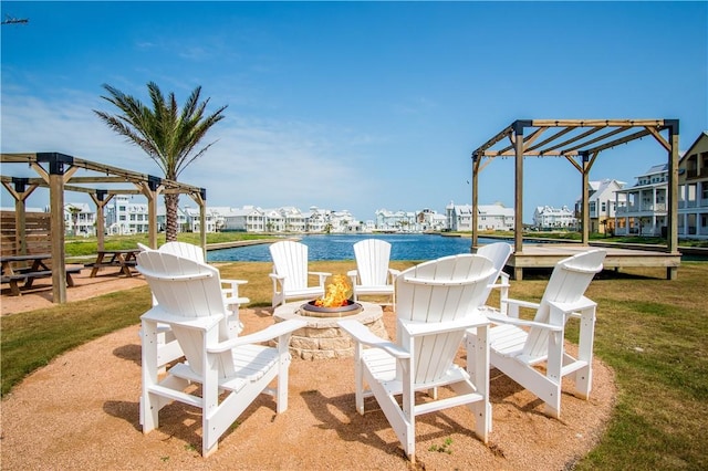 view of patio featuring a water view and an outdoor fire pit