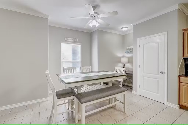 tiled dining area with ceiling fan and crown molding