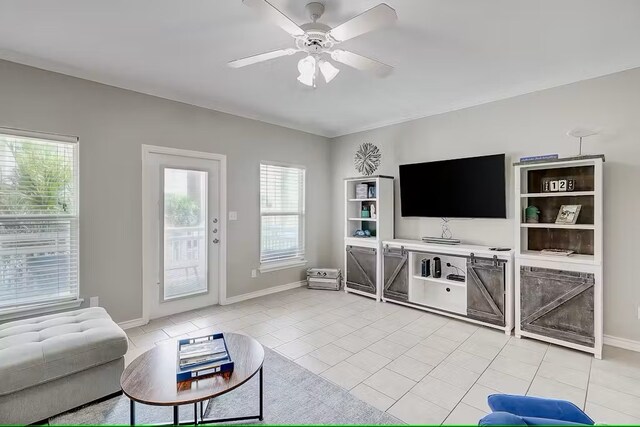 tiled living room featuring ceiling fan