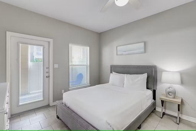 bedroom featuring light tile patterned floors, ceiling fan, and access to exterior