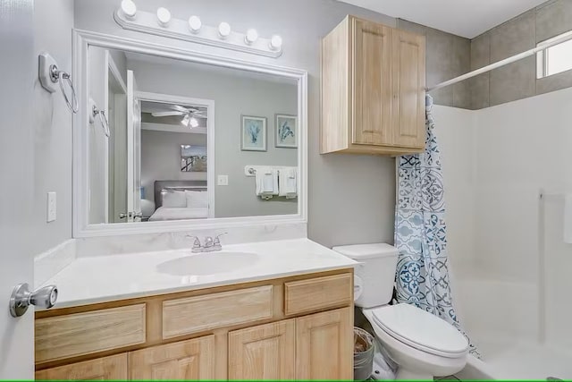 bathroom with curtained shower, vanity, ceiling fan, and toilet