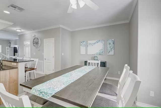 dining space featuring ceiling fan and ornamental molding