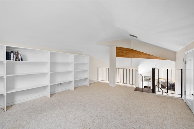 bonus room featuring lofted ceiling, carpet floors, and visible vents