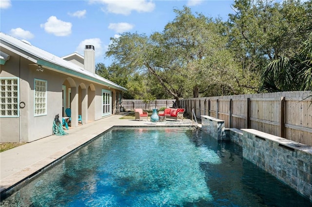 view of swimming pool featuring a patio area, a fenced backyard, and a fenced in pool