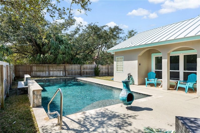 view of swimming pool featuring a patio area, a fenced backyard, and a fenced in pool