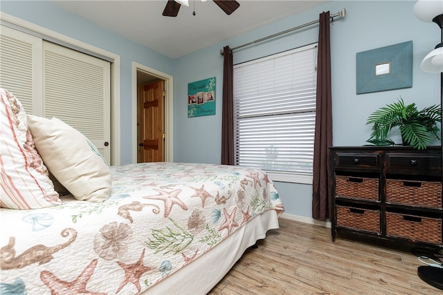 bedroom with ceiling fan, a closet, and light wood-type flooring