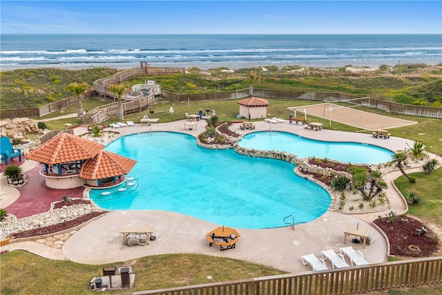 view of pool with a patio, a water view, and a yard