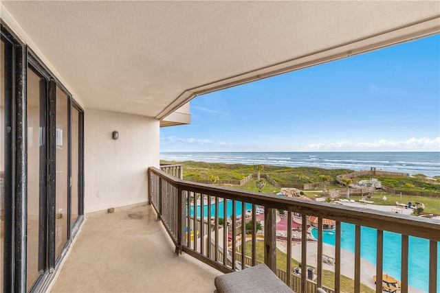 balcony with a beach view and a water view