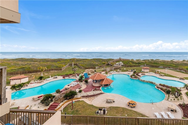 view of swimming pool featuring a patio and a water view