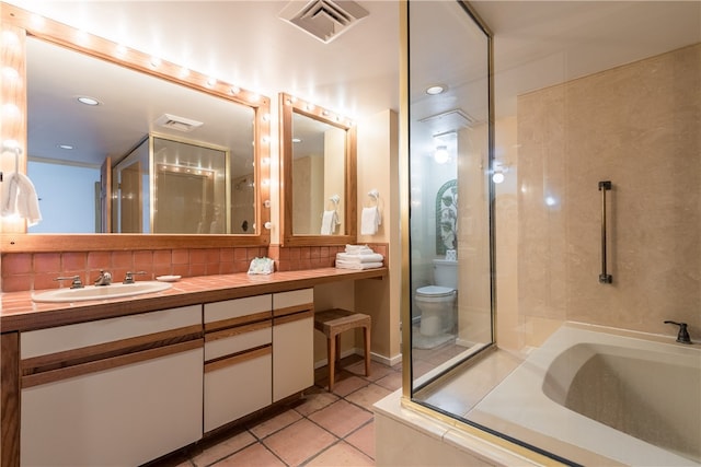 bathroom featuring toilet, vanity, and tile patterned flooring