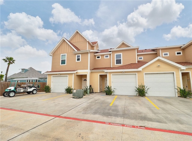 view of front of property featuring central AC unit and a garage