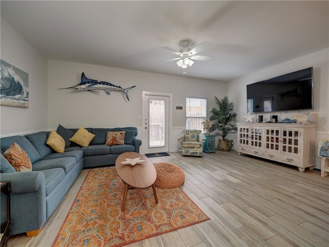 living room with light hardwood / wood-style floors and ceiling fan