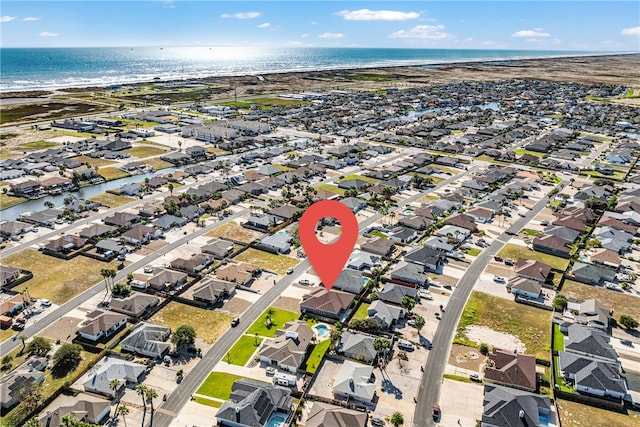 birds eye view of property featuring a beach view and a water view