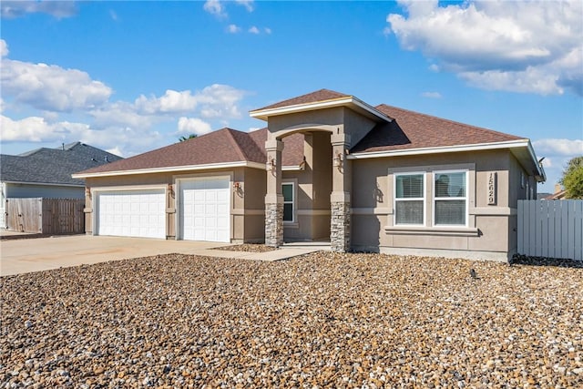 15629 Escapade St, Corpus Christi, TX 78418 - view of front of home with stucco siding, an attached garage, concrete driveway, and roof with shingles