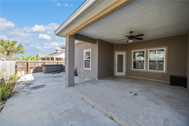 view of patio featuring ceiling fan and a hot tub