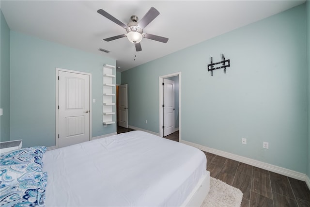 bedroom with ceiling fan and dark hardwood / wood-style floors