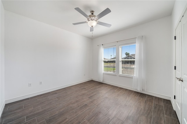 unfurnished room featuring ceiling fan and dark wood-type flooring