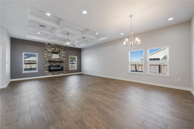 unfurnished living room with coffered ceiling, a fireplace, wood-type flooring, and ceiling fan with notable chandelier