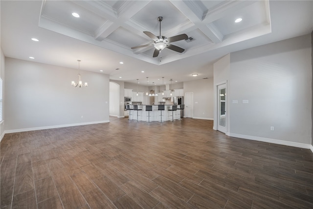 unfurnished living room with beam ceiling, coffered ceiling, dark wood-type flooring, and ceiling fan with notable chandelier