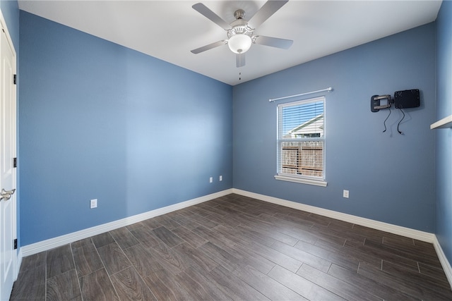 empty room featuring ceiling fan and dark wood-type flooring