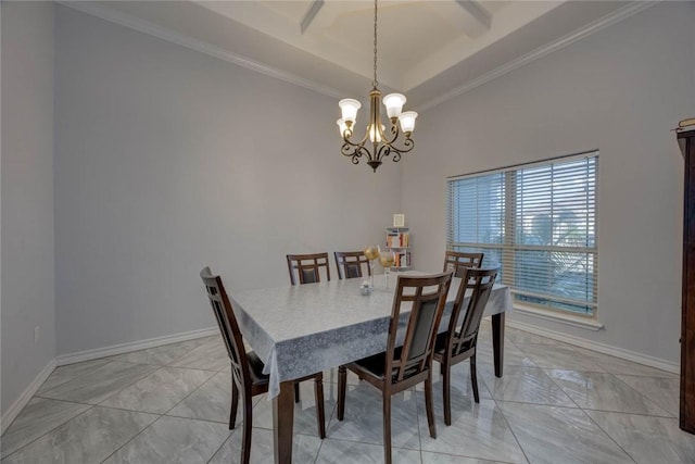 dining room with a raised ceiling, ornamental molding, and an inviting chandelier