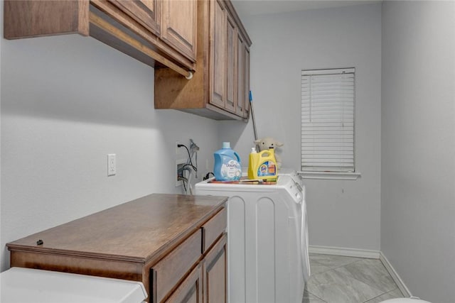 laundry area featuring cabinets and washer and clothes dryer