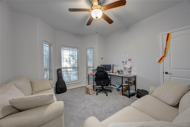 office space featuring light carpet and ceiling fan