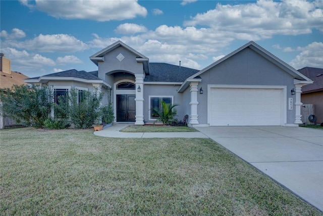 view of front facade with a garage and a front lawn