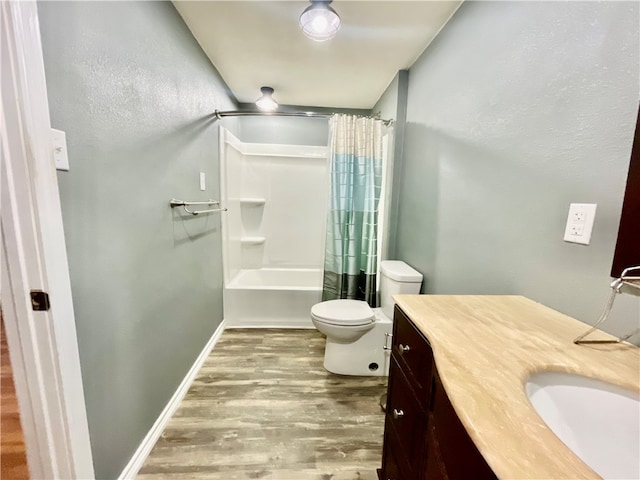 full bathroom with toilet, shower / tub combo, vanity, and wood-type flooring