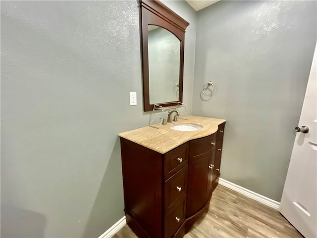 bathroom with hardwood / wood-style floors and vanity