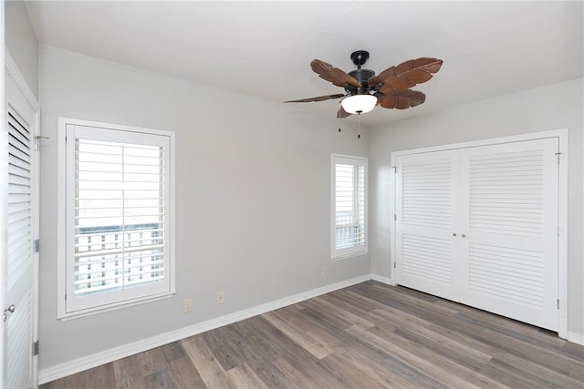 200 W Cotter Ave Unit B-3, Port Aransas, TX 78373 - unfurnished bedroom featuring wood finished floors, baseboards, a closet, and a ceiling fan