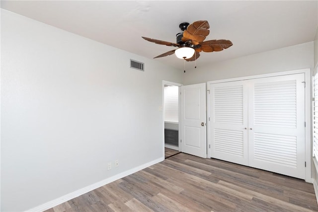 200 W Cotter Ave Unit B-3, Port Aransas, TX 78373 - unfurnished bedroom with wood finished floors, baseboards, a closet, and ceiling fan