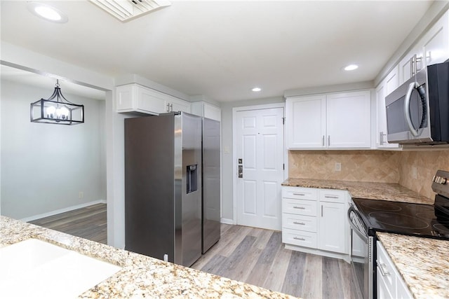 200 W Cotter Ave Unit B-3, Port Aransas, TX 78373 - kitchen with stainless steel appliances, light wood-style floors, white cabinets, backsplash, and recessed lighting