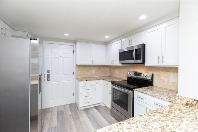 200 W Cotter Ave Unit B-3, Port Aransas, TX 78373 - kitchen featuring stainless steel appliances, light wood-type flooring, white cabinetry, and recessed lighting