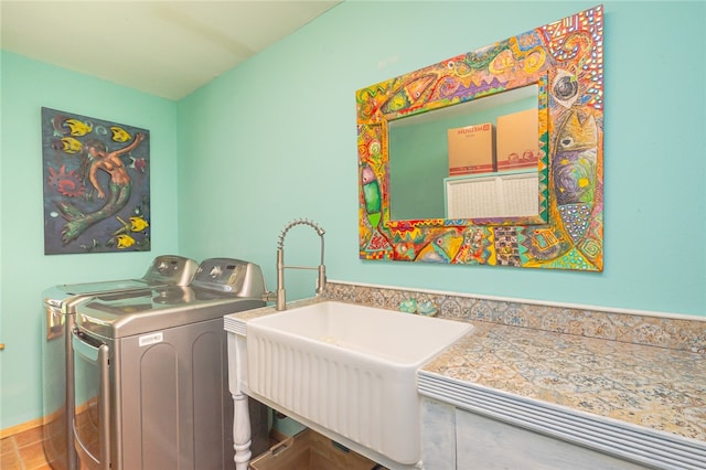 washroom featuring separate washer and dryer and sink