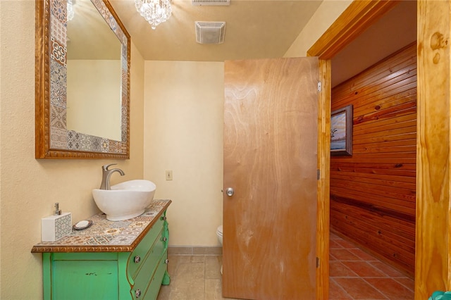 bathroom with tile patterned flooring, vanity, and toilet