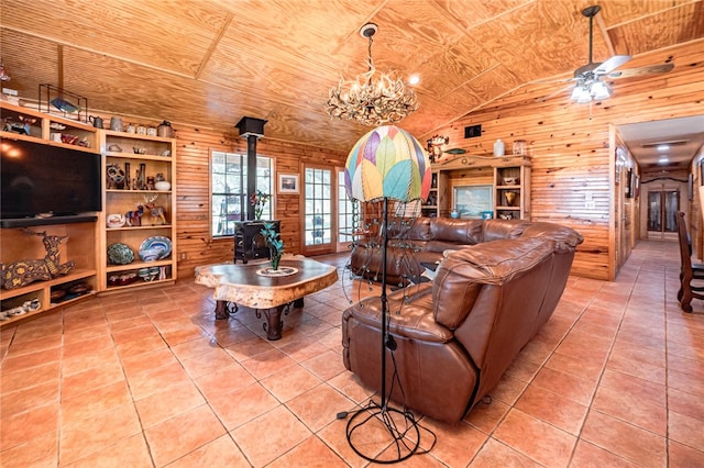 tiled living room featuring wood ceiling, wooden walls, a wood stove, and vaulted ceiling