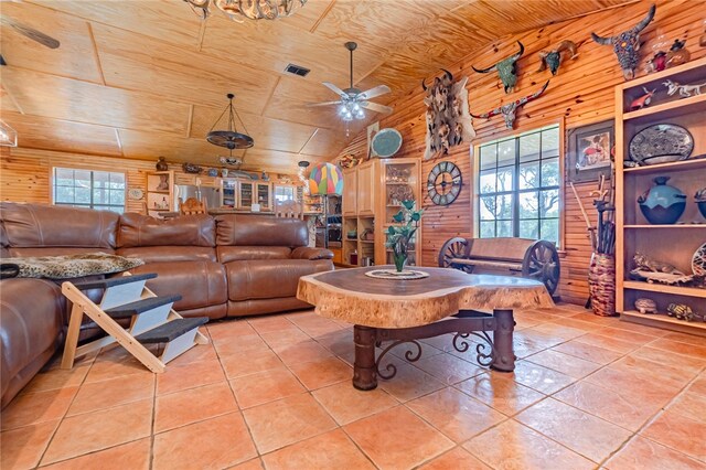 tiled living room featuring wooden ceiling, ceiling fan, wood walls, and lofted ceiling