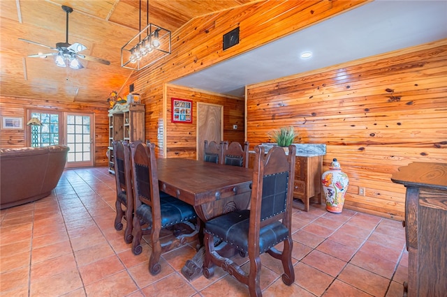 tiled dining area featuring wood walls, ceiling fan, wood ceiling, and vaulted ceiling